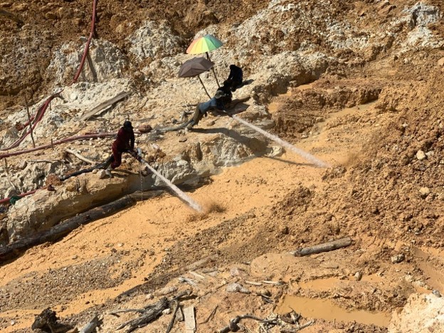 Mining site with tent structures and workers